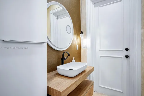 a bathroom with a sink mirror and vanity