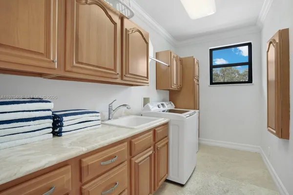 a kitchen with stainless steel appliances granite countertop a sink and cabinets with wooden floor