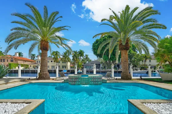 a view of a swimming pool with a garden and patio