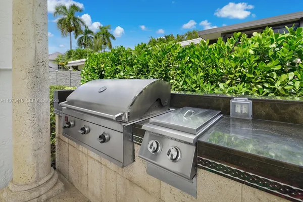 a view of barbeque grill with granite counter top