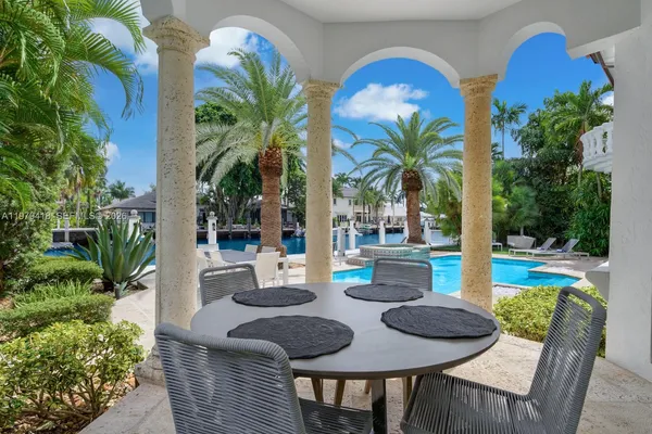 a view of an outdoor dining space with a table and chairs