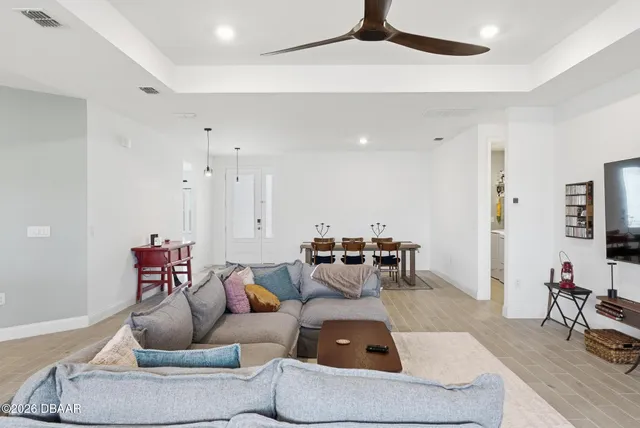 a kitchen with a sink a counter top space and living room area
