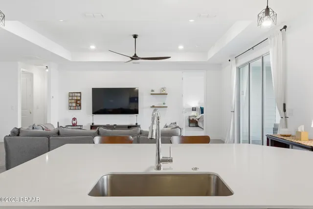 a bedroom with a bed and a ceiling fan