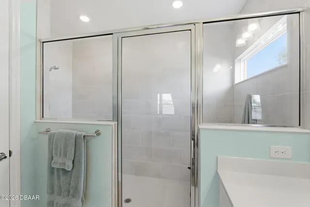 a bedroom with a bed and a ceiling fan