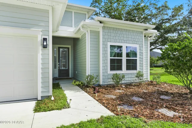 a front view of a house with garden