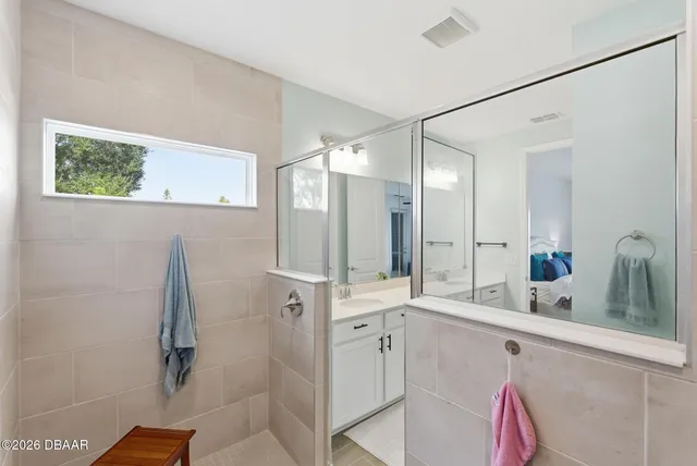 a living room with couch and a floor to ceiling window