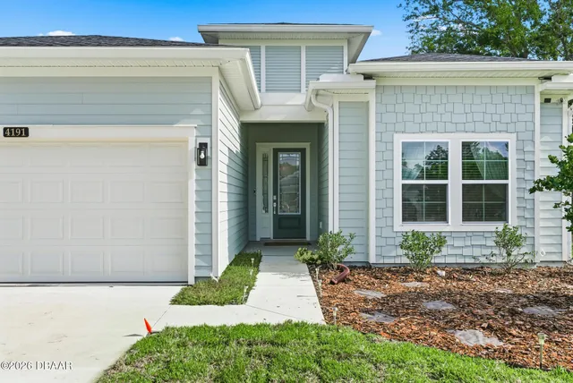 a living room with furniture a desk and chair with wooden floor