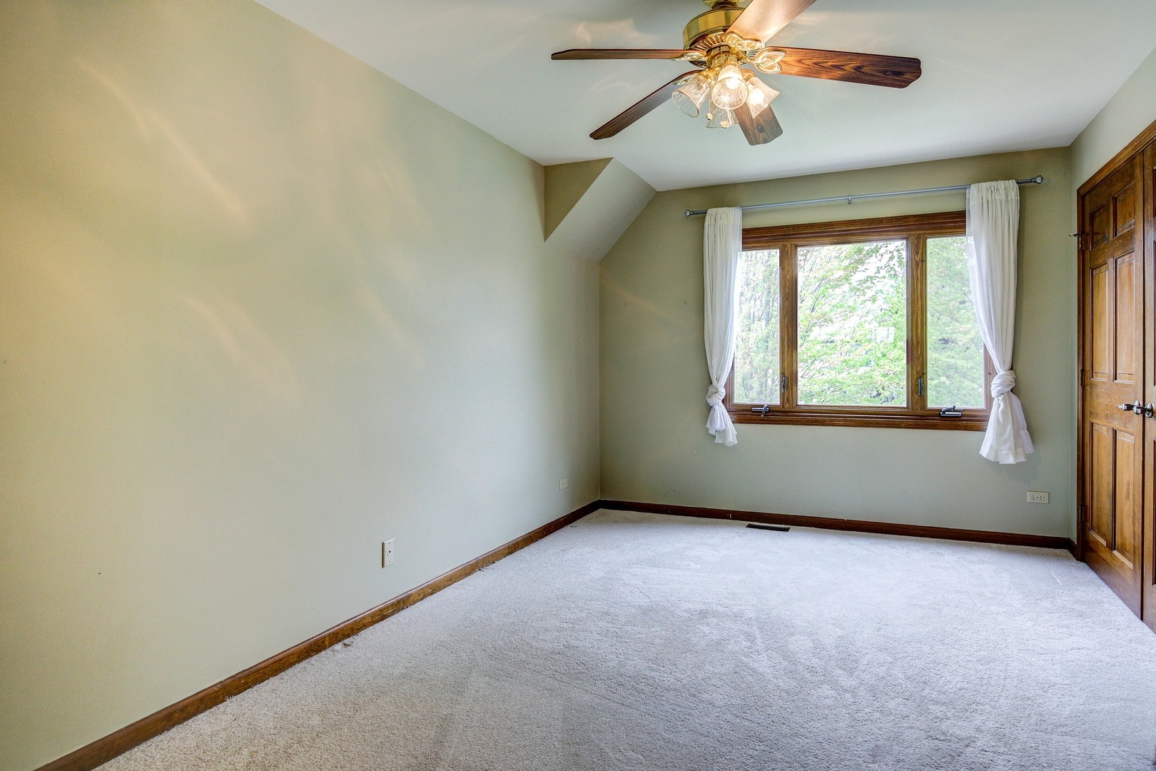 1945 Slippery Rock Road Naperville, IL 60565 - Photo 21 of 35 an empty room with windows and fan