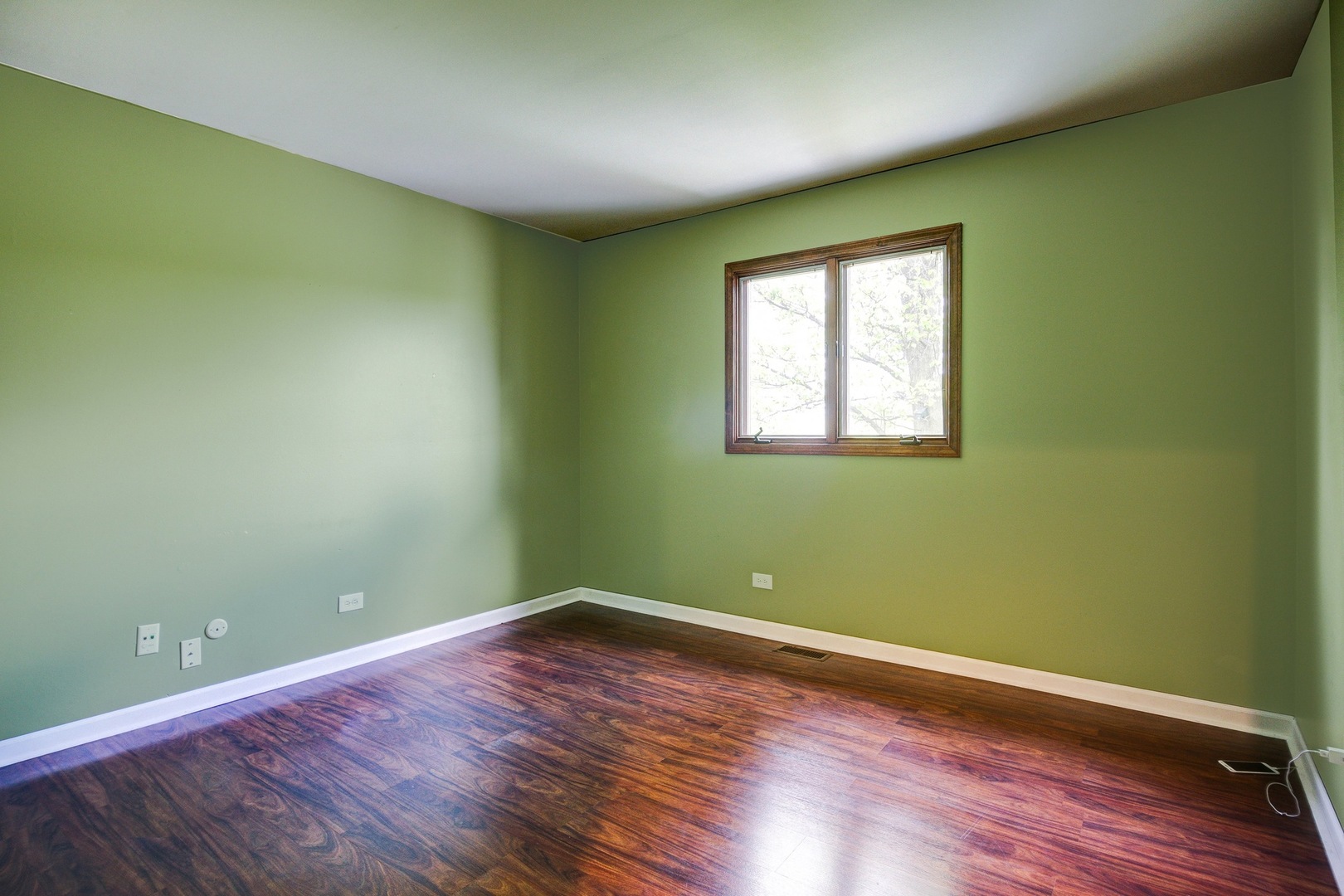 1945 Slippery Rock Road Naperville, IL 60565 - Photo 22 of 35 a view of a room with wooden floor and windows