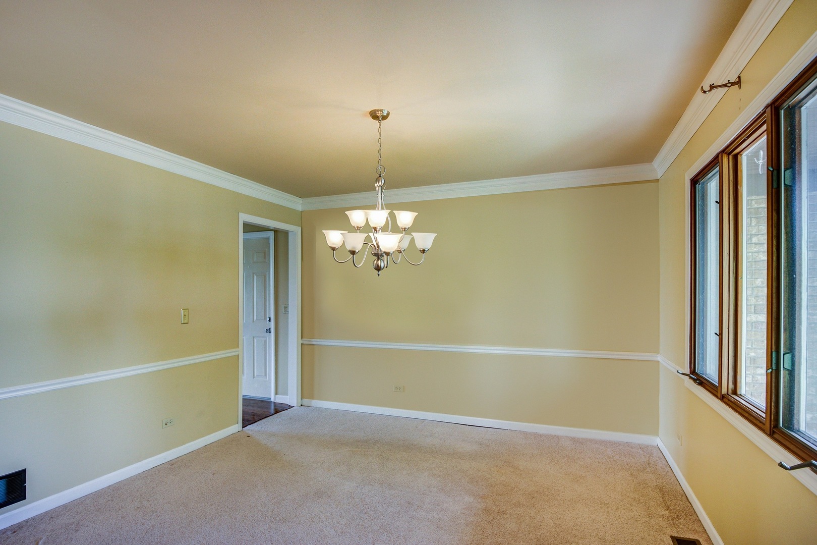 1945 Slippery Rock Road Naperville, IL 60565 - Photo 4 of 35 a view of an empty room with window and chandelier