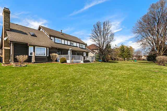 1945 Slippery Rock Road Naperville, IL 60565 - Photo 33 of 35 a front view of a house with a garden and trees