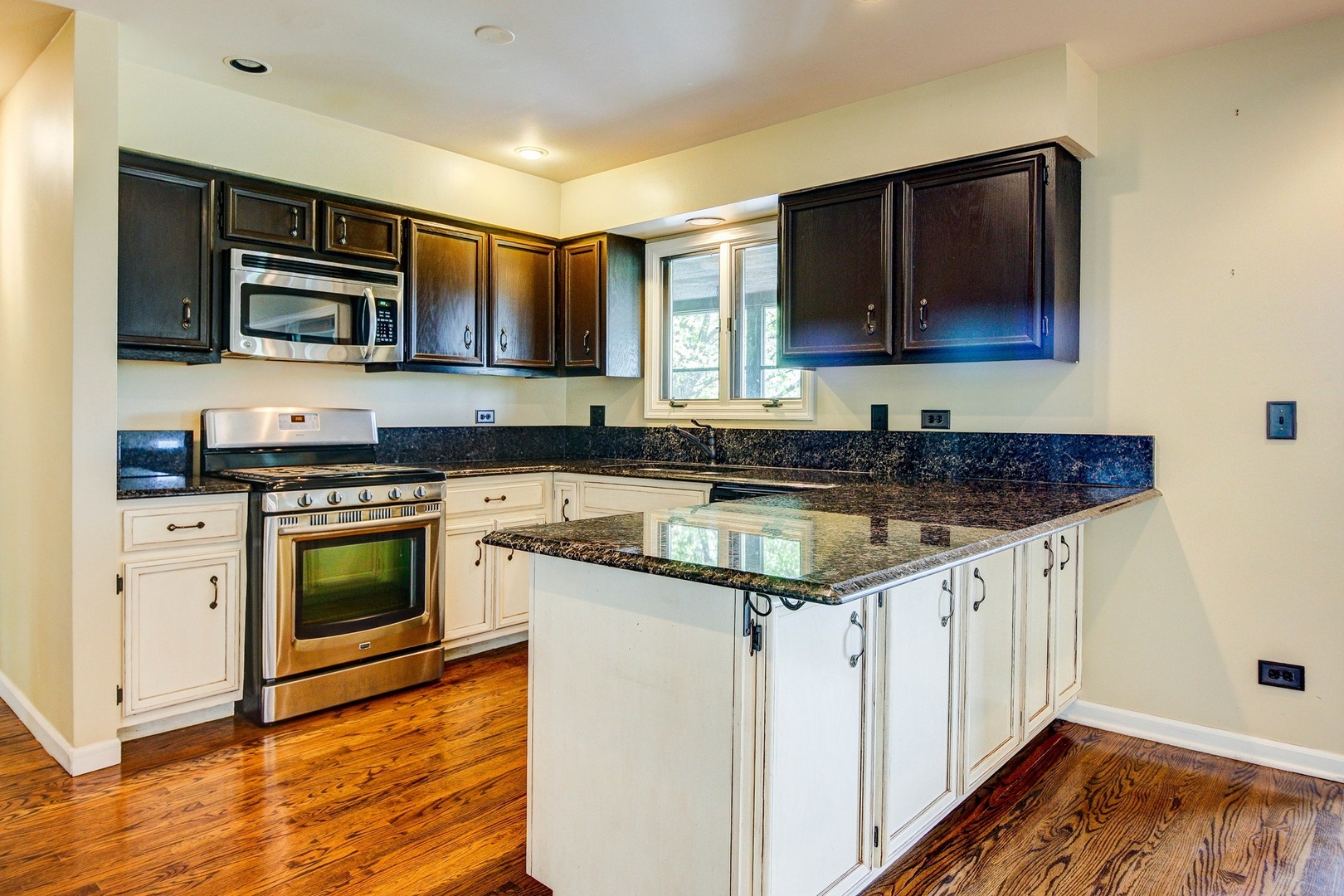 1945 Slippery Rock Road Naperville, IL 60565 - Photo 5 of 35 a kitchen with stainless steel appliances granite countertop a stove microwave and cabinets
