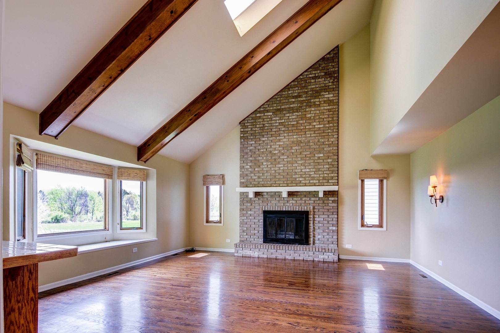 1945 Slippery Rock Road Naperville, IL 60565 - Photo 9 of 35 a view of an empty room with wooden floor fireplace and a window