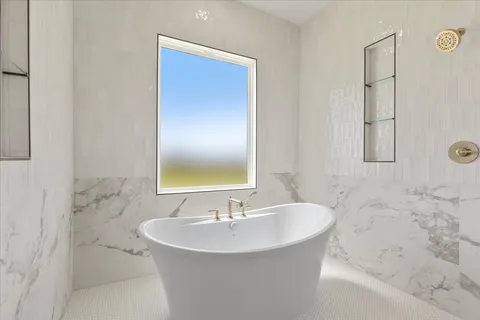 a bathroom with a tub and a shower