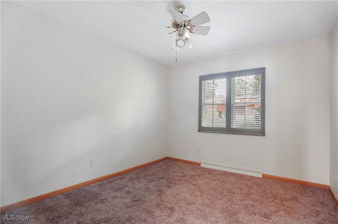 3215 Stanley Road Akron, OH 44333 - Photo 22 of 30 Spare room with carpet flooring, a ceiling fan, and a baseboard radiator