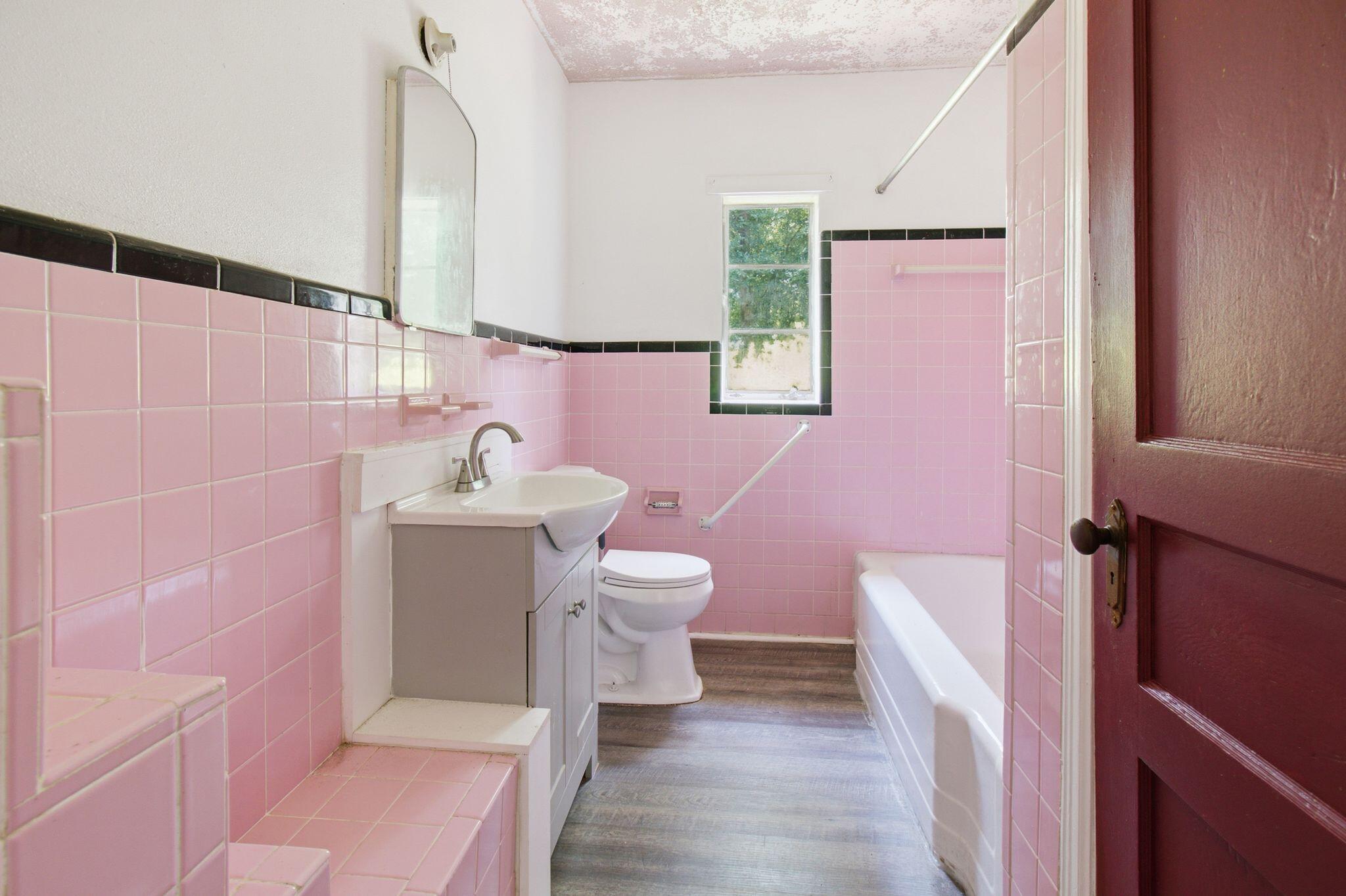 855 North Pearl Street Crestview, FL 32536 - Photo 15 of 31 a bathroom with a sink a toilet a mirror and vanity