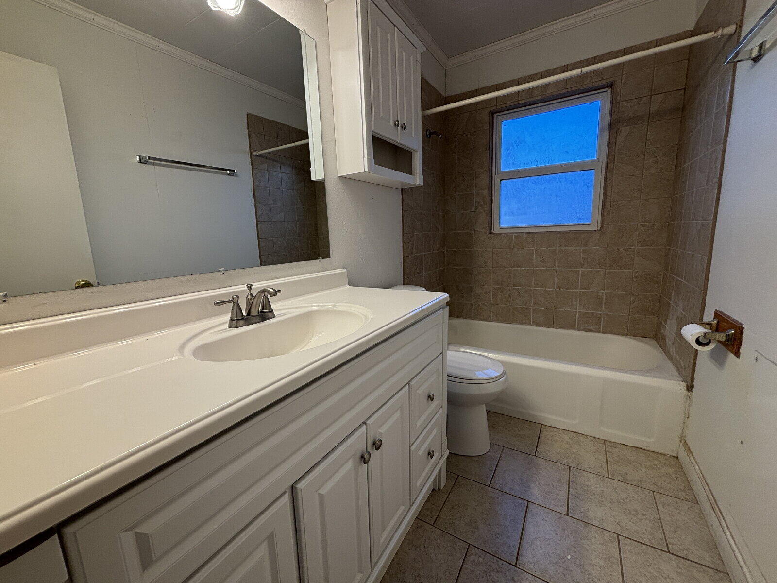 2318 20th Street Lubbock, TX 79411 - Photo 9 of 10 a bathroom with a sink a toilet and shower