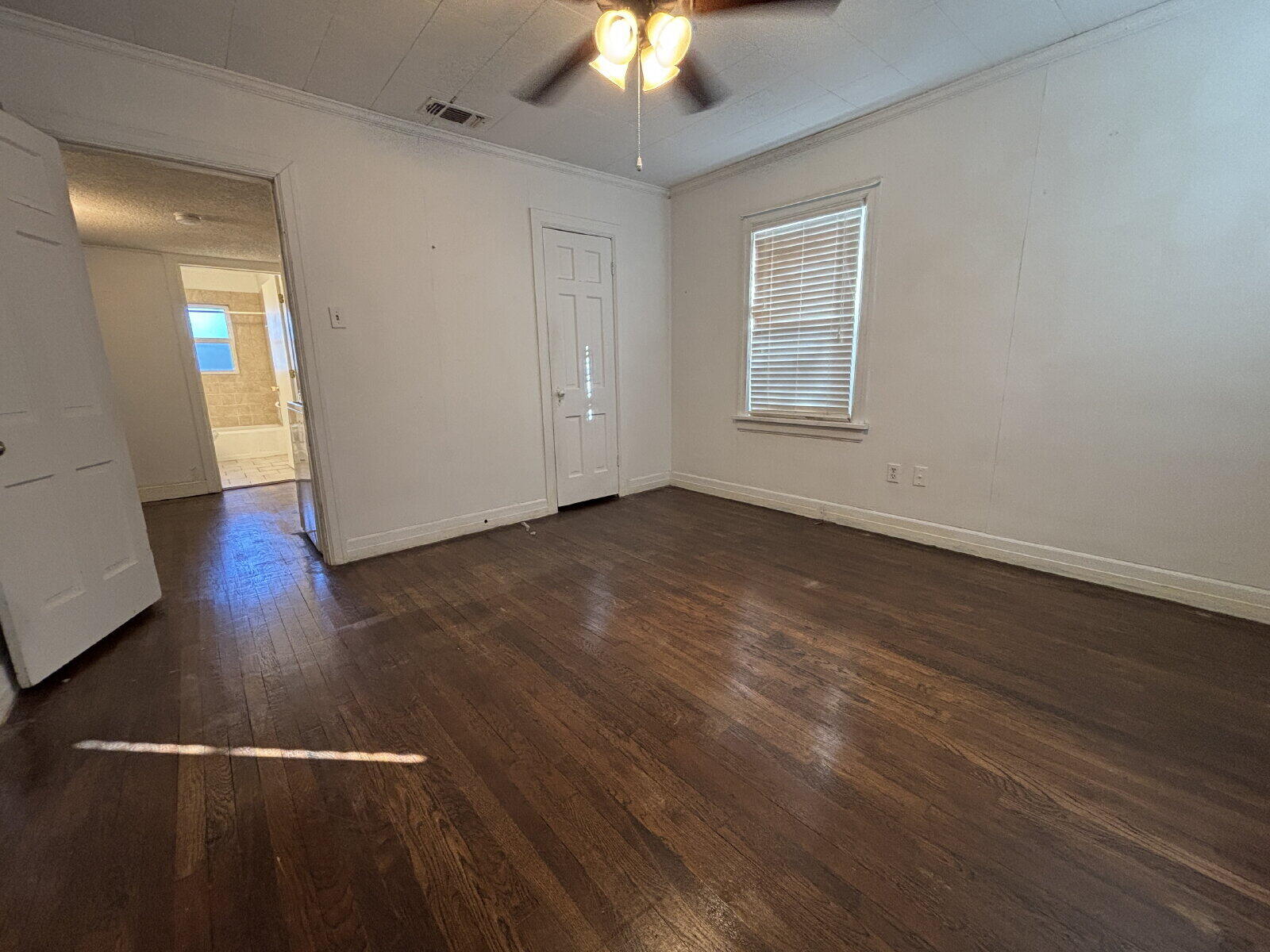2318 20th Street Lubbock, TX 79411 - Photo 10 of 10 a view of an empty room with wooden floor fan and window