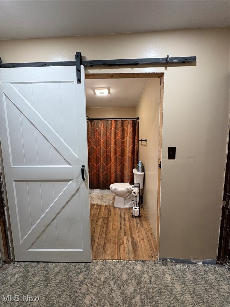 4542 Bloomfield Road Cambridge, OH 43725 - Photo 13 of 22 Hallway and entrance to bathroom featuring sliding barn door