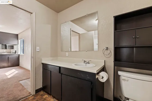 a kitchen with kitchen island sink and refrigerator