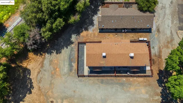 an aerial view of a house with a yard