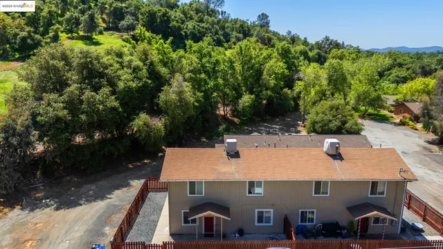 an aerial view of a house with yard