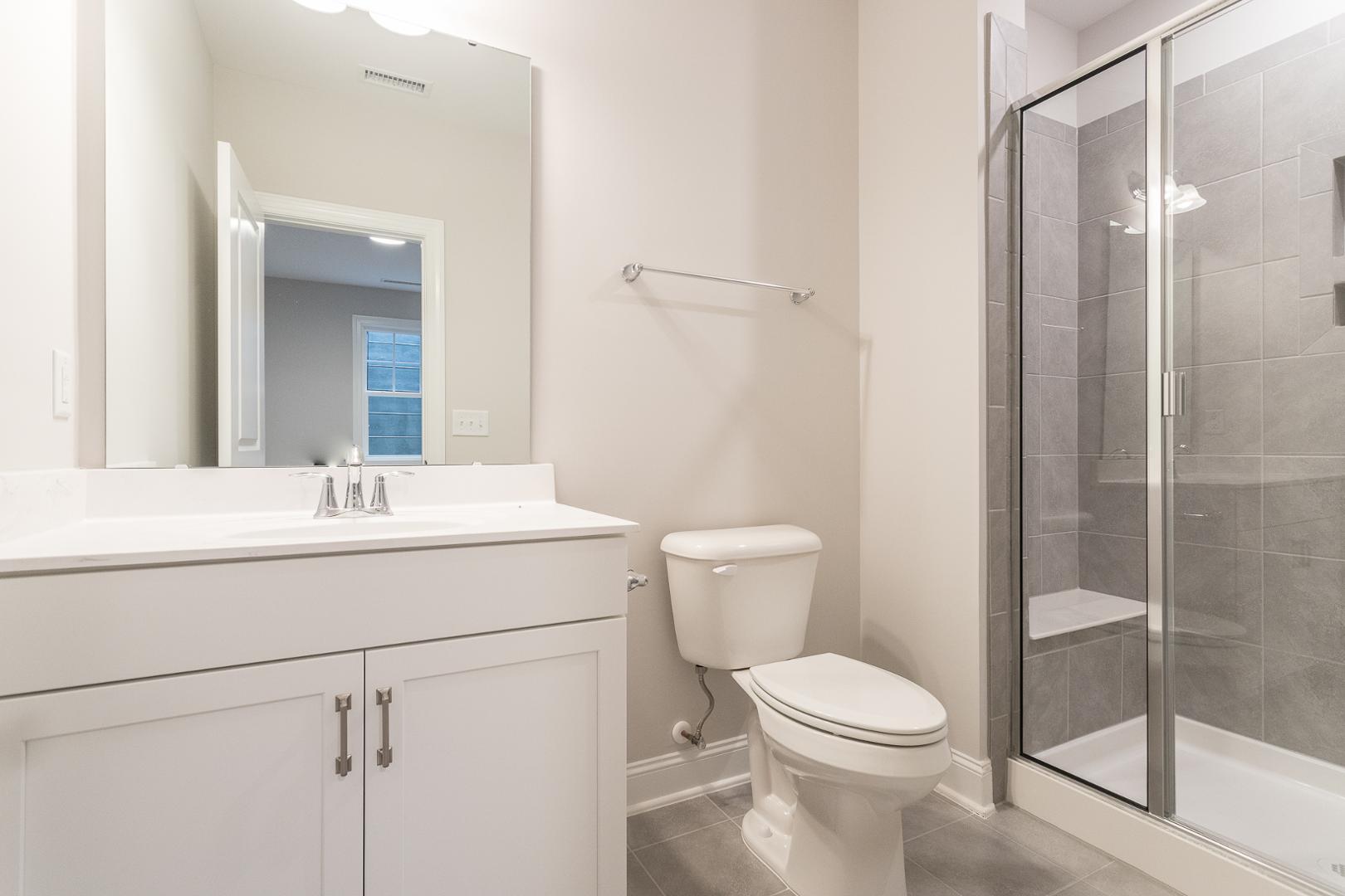 8421 Zinc Autumn Path Raleigh, NC 27615 - Photo 11 of 33 a bathroom with a toilet sink and shower