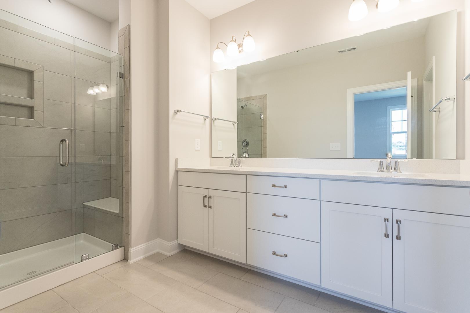 8421 Zinc Autumn Path Raleigh, NC 27615 - Photo 14 of 33 a bathroom with a shower sink and mirror
