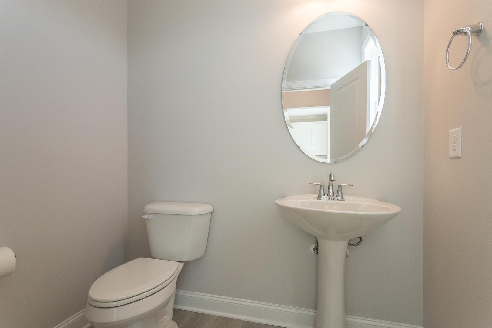 8421 Zinc Autumn Path Raleigh, NC 27615 - Photo 15 of 33 a bathroom with a toilet sink and mirror