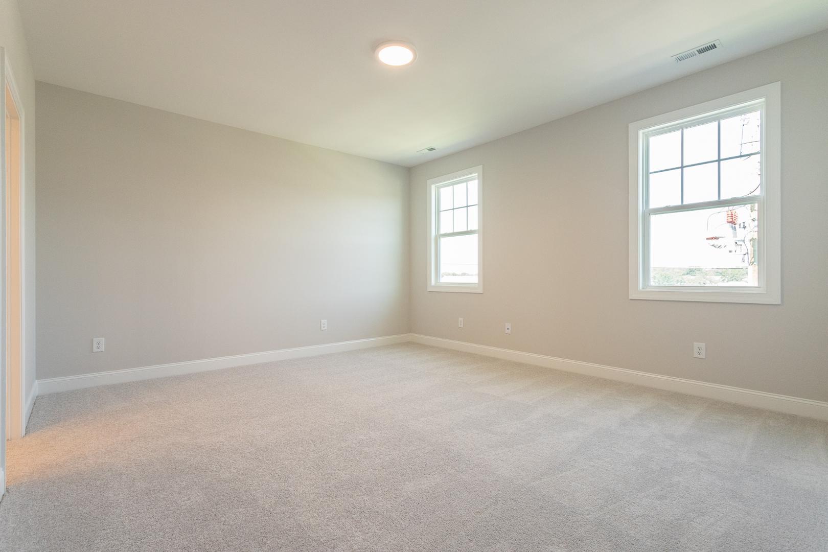 8421 Zinc Autumn Path Raleigh, NC 27615 - Photo 17 of 33 an empty room with windows