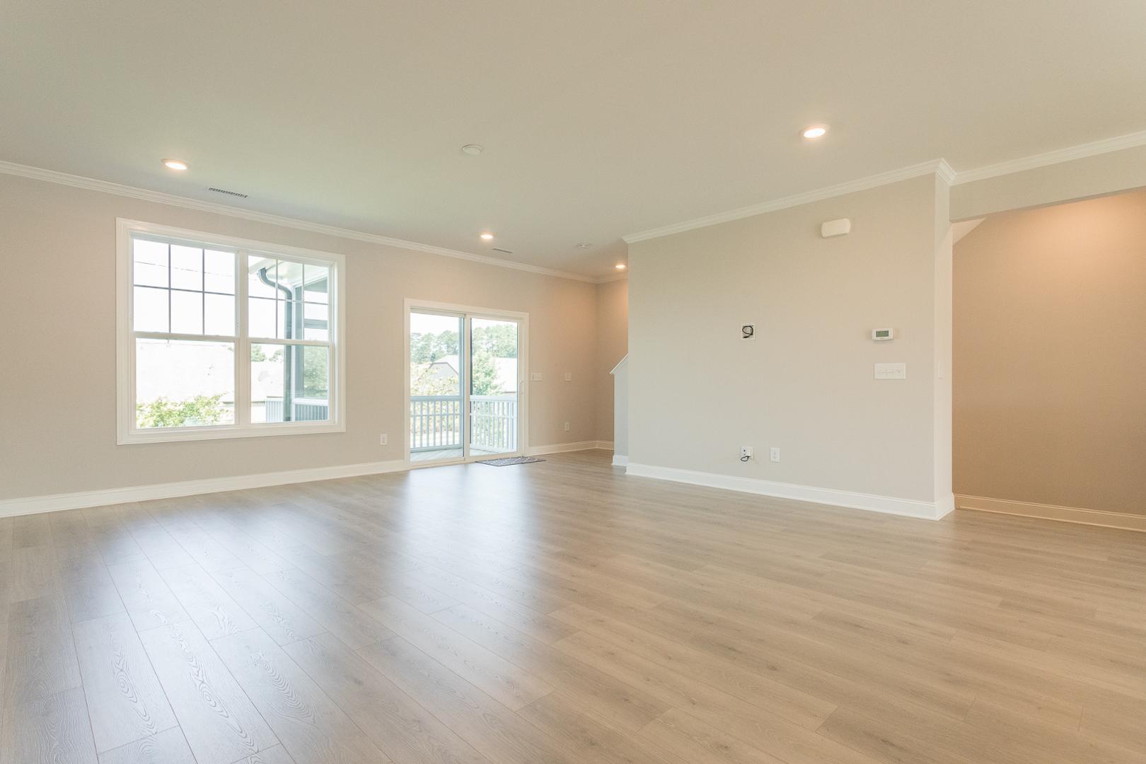 8421 Zinc Autumn Path Raleigh, NC 27615 - Photo 19 of 33 an empty room with wooden floor and windows with curtains