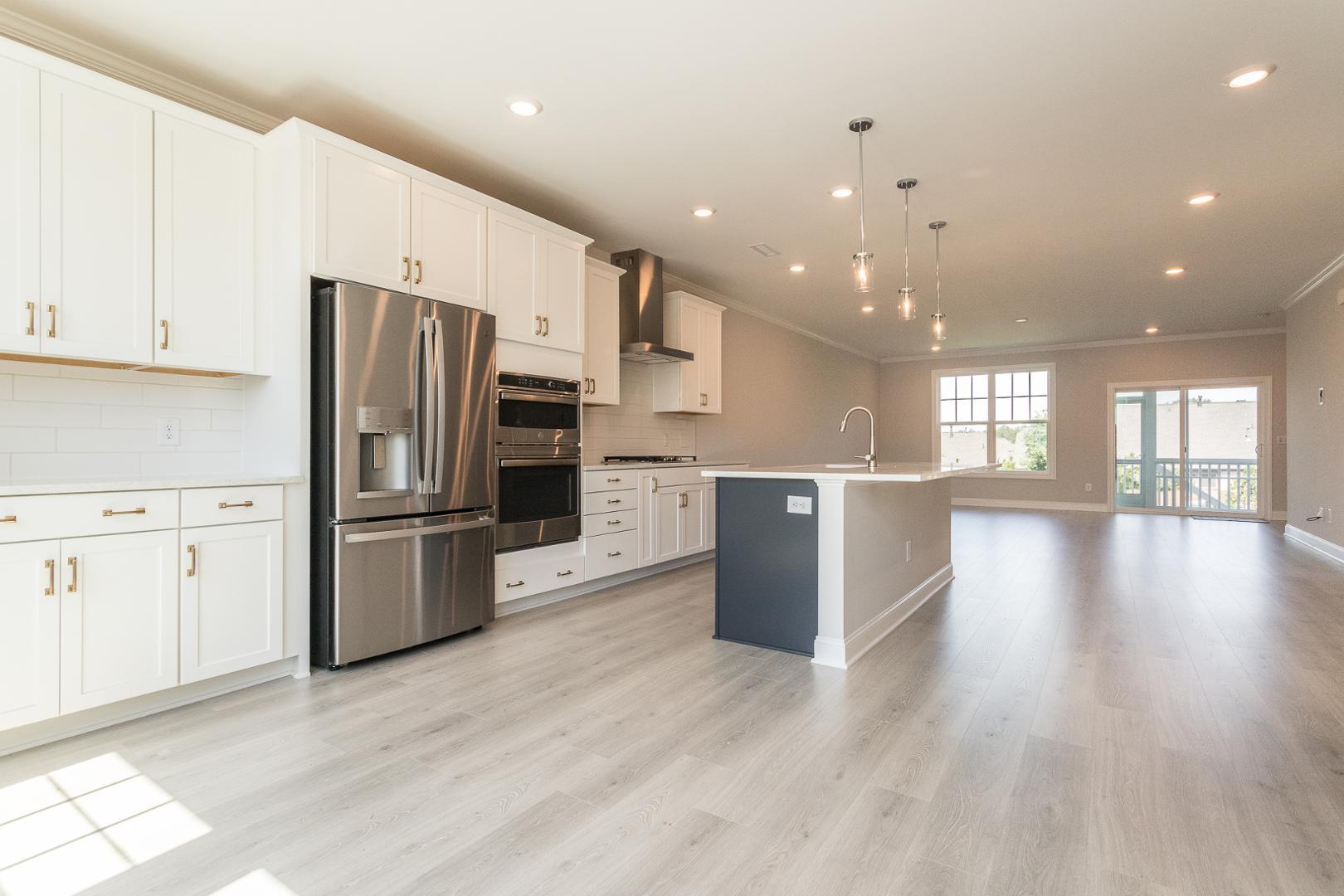 8421 Zinc Autumn Path Raleigh, NC 27615 - Photo 2 of 33 a kitchen with stainless steel appliances a refrigerator and wooden floor