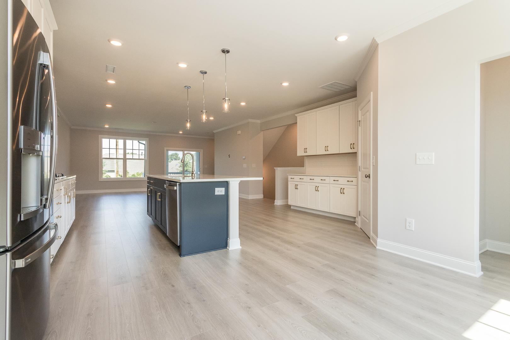 8421 Zinc Autumn Path Raleigh, NC 27615 - Photo 24 of 33 a view of a kitchen with a sink and a refrigerator