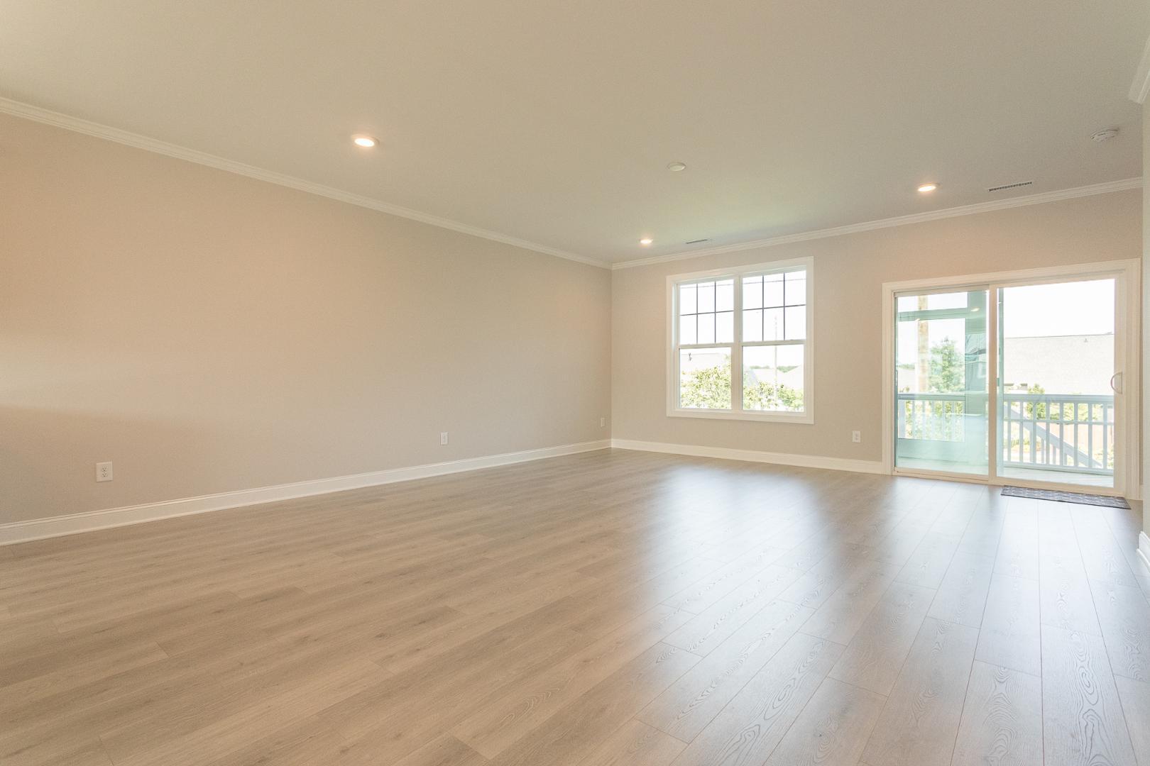 8421 Zinc Autumn Path Raleigh, NC 27615 - Photo 25 of 33 an empty room with wooden floor and windows