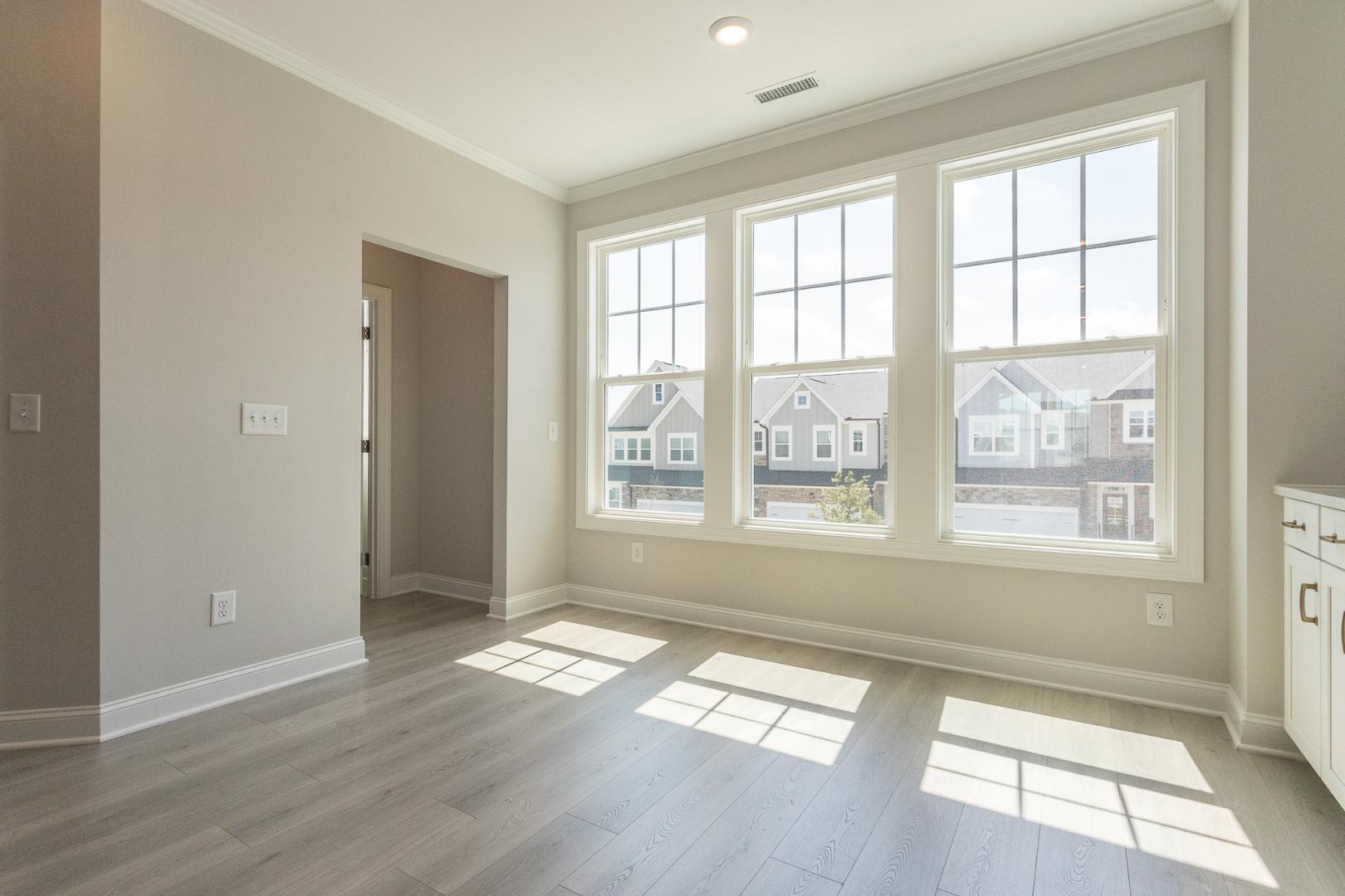 8421 Zinc Autumn Path Raleigh, NC 27615 - Photo 26 of 33 an empty room with wooden floor and windows