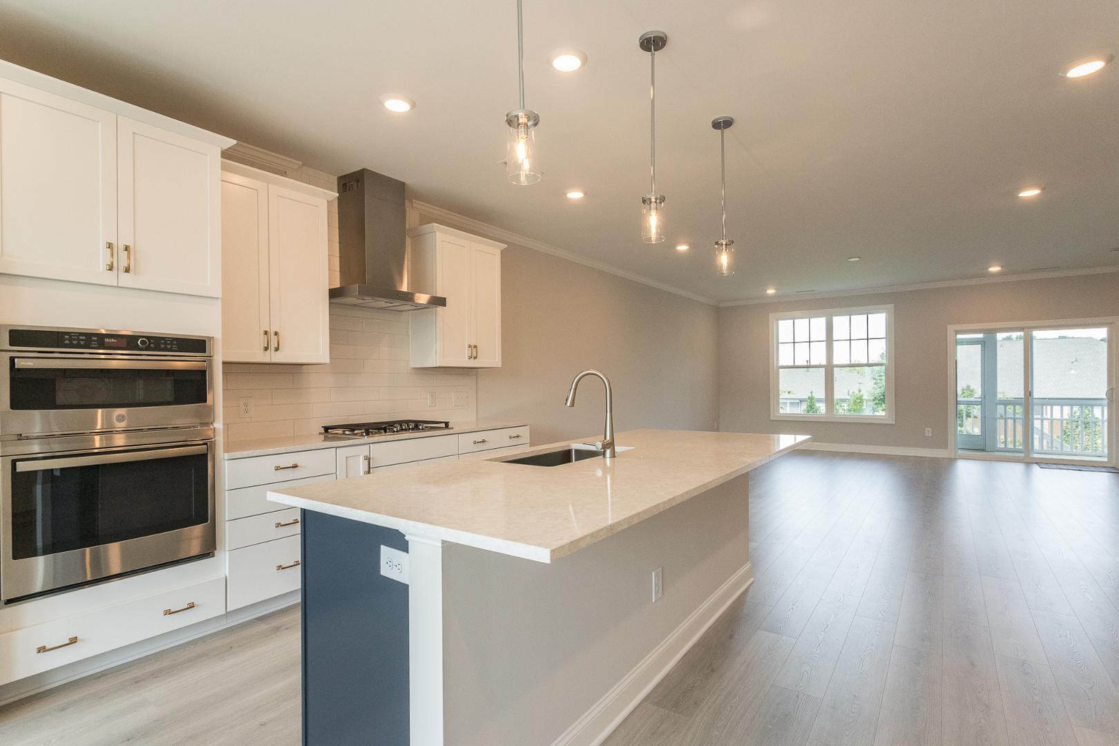 8421 Zinc Autumn Path Raleigh, NC 27615 - Photo 3 of 33 a kitchen with a stove a sink a microwave a counter top space and cabinets