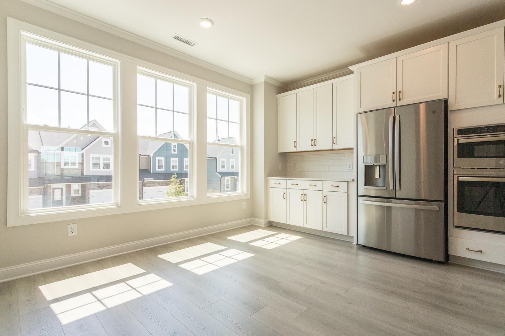 8421 Zinc Autumn Path Raleigh, NC 27615 - Photo 4 of 33 a kitchen with stainless steel appliances a refrigerator sink and cabinets