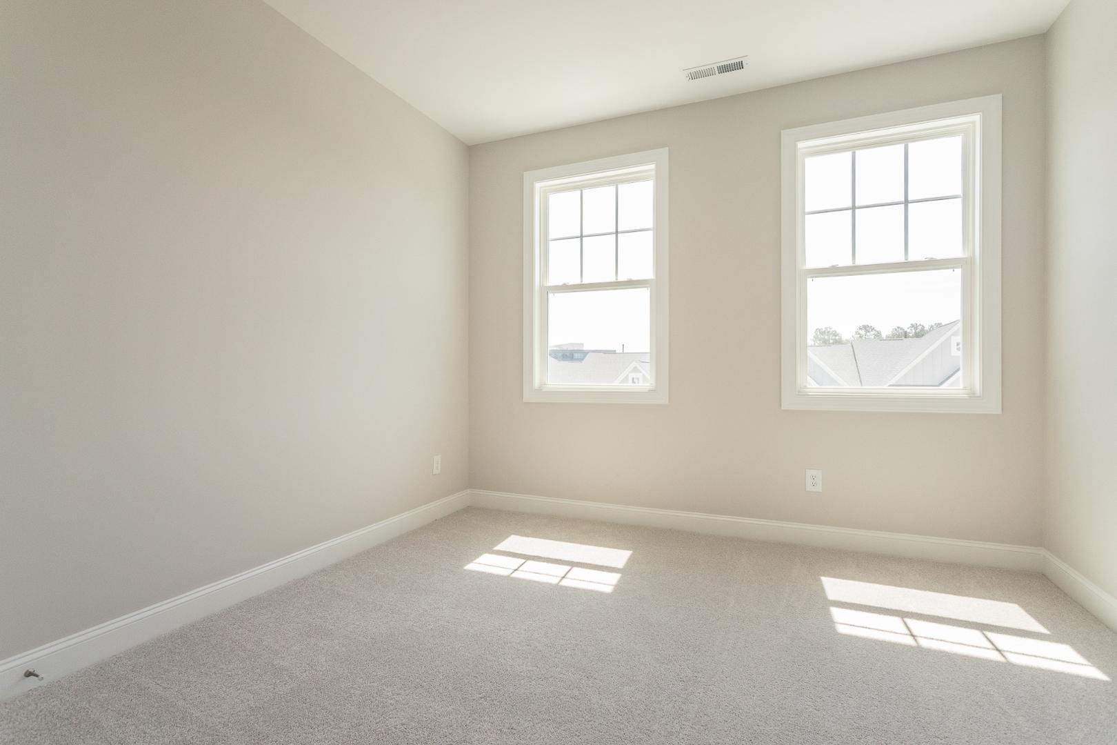 8421 Zinc Autumn Path Raleigh, NC 27615 - Photo 10 of 33 an empty room with windows