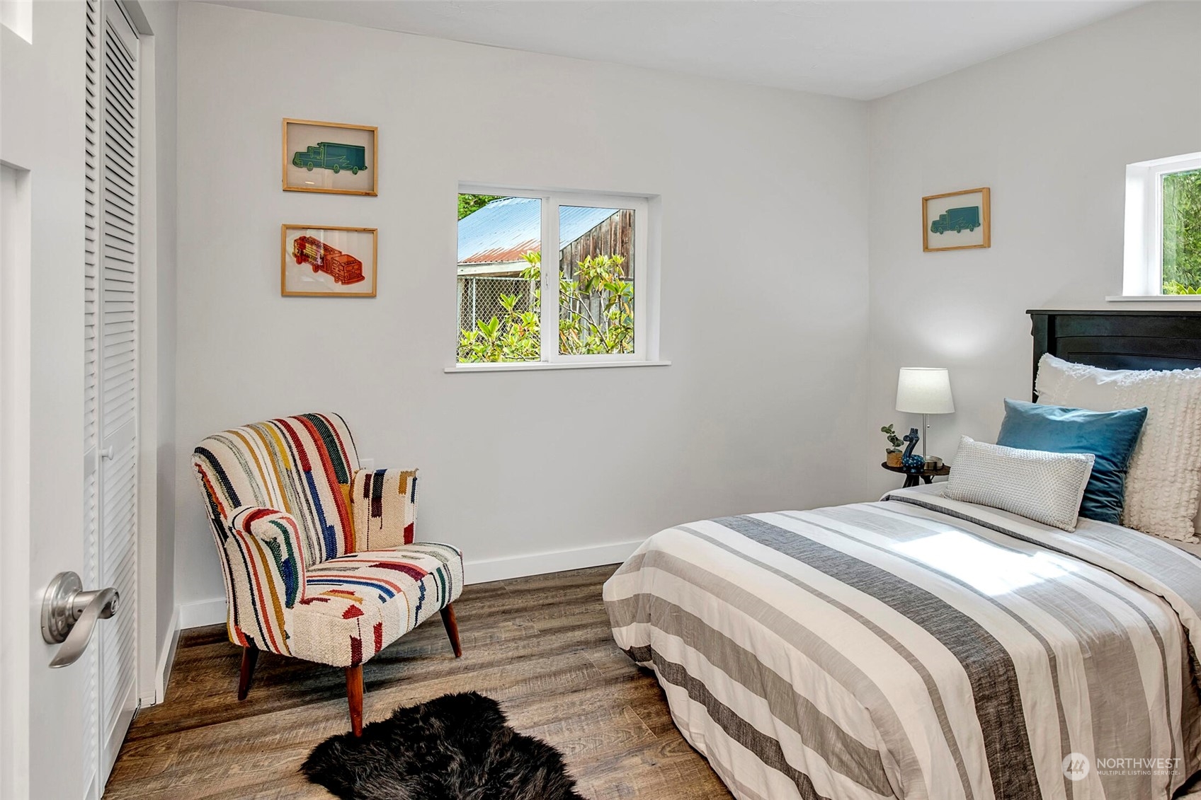 29316 Lake Chaplain Road Monroe, WA 98272 - Photo 8 of 18 a bedroom with a bed and wooden floor