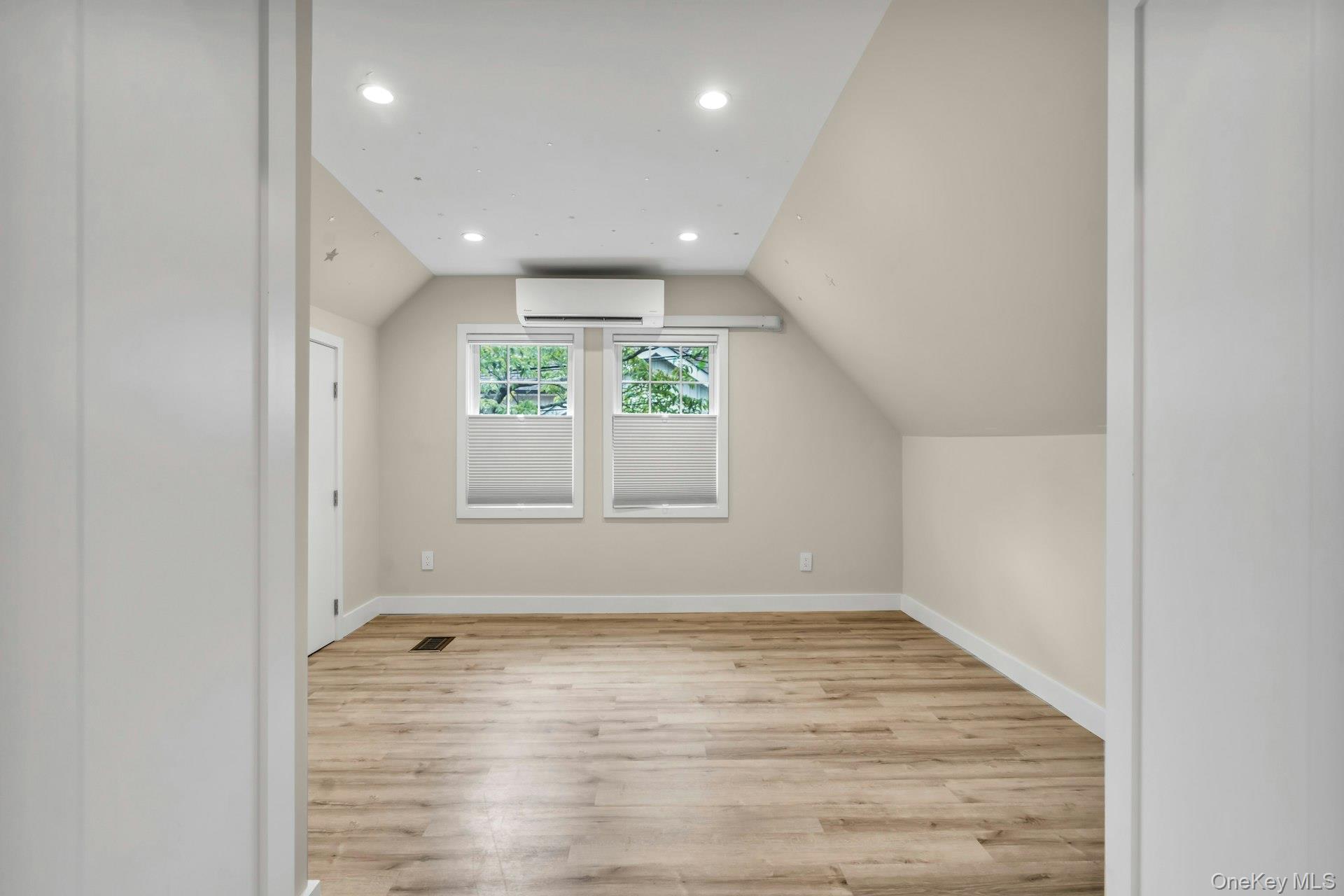 20 Robert Road Glen Cove, NY 11542 - Photo 18 of 24 an empty room with wooden floor and windows