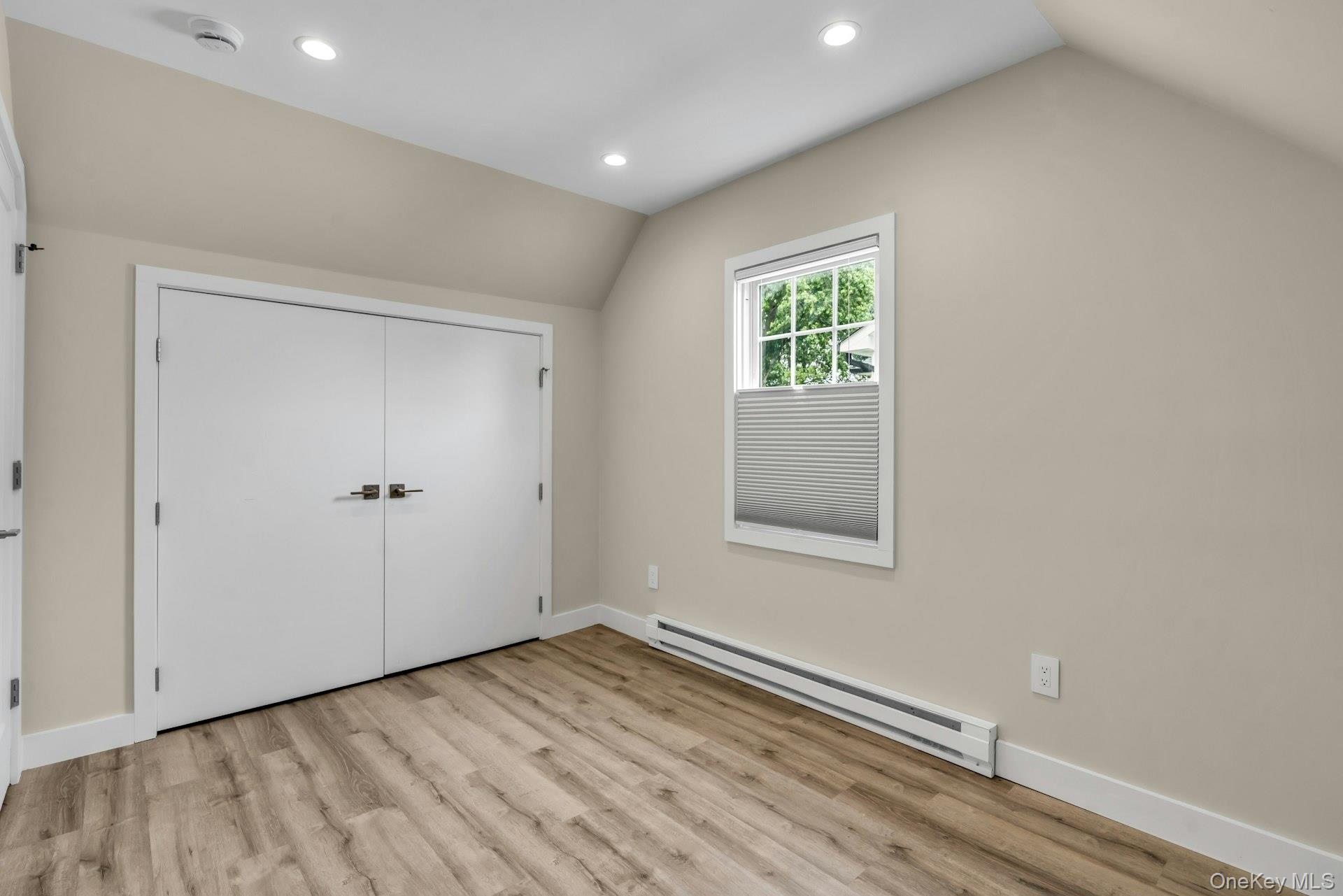 20 Robert Road Glen Cove, NY 11542 - Photo 20 of 24 an empty room with wooden floor and windows