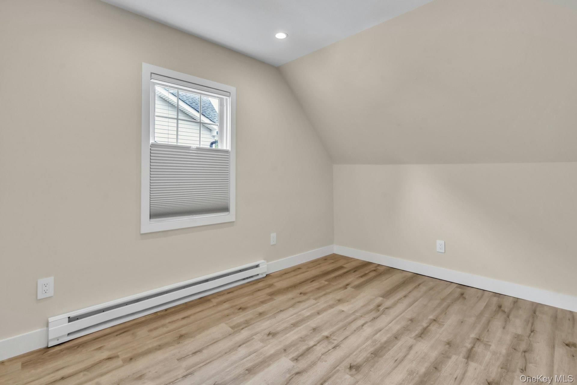 20 Robert Road Glen Cove, NY 11542 - Photo 21 of 24 an empty room with wooden floor and windows