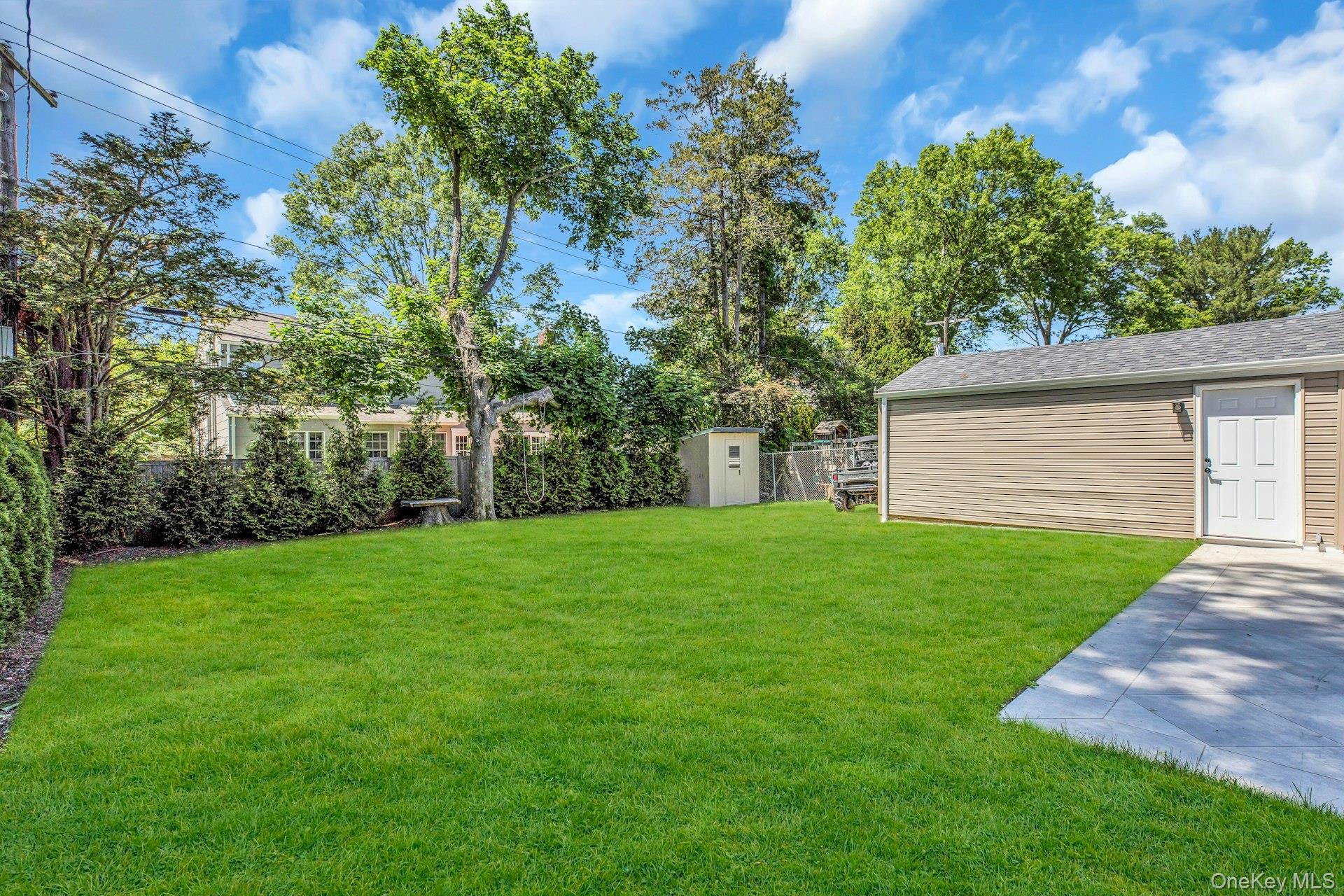 20 Robert Road Glen Cove, NY 11542 - Photo 24 of 24 a view of a backyard with a garden