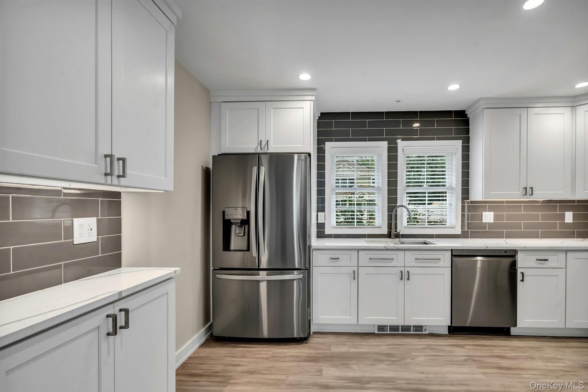 20 Robert Road Glen Cove, NY 11542 - Photo 7 of 24 a kitchen with a refrigerator and a sink