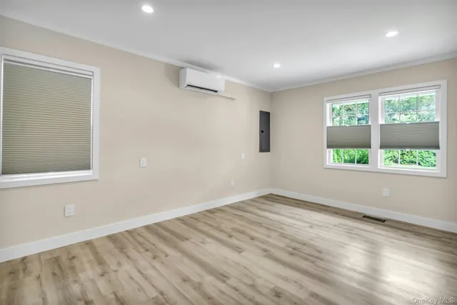 wooden floor in an empty room with a window