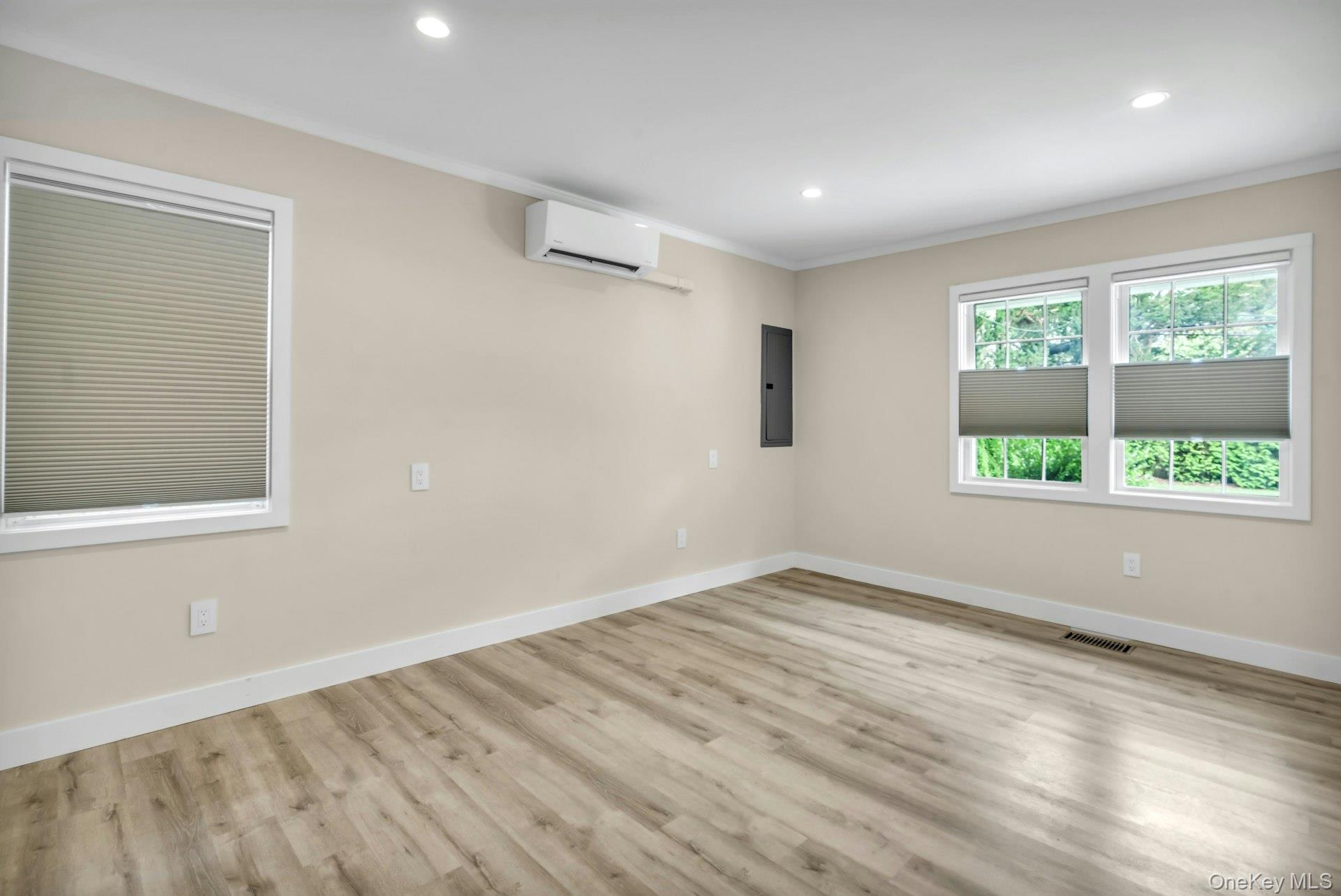 20 Robert Road Glen Cove, NY 11542 - Photo 10 of 24 wooden floor in an empty room with a window