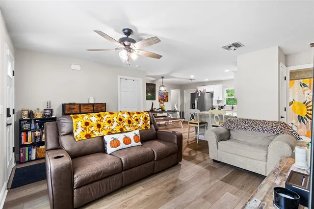 a living room with furniture and a wooden floor