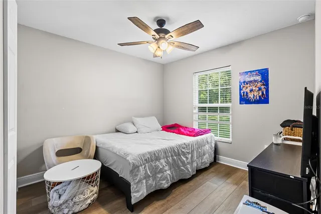 a bed sitting in a bedroom next to a window