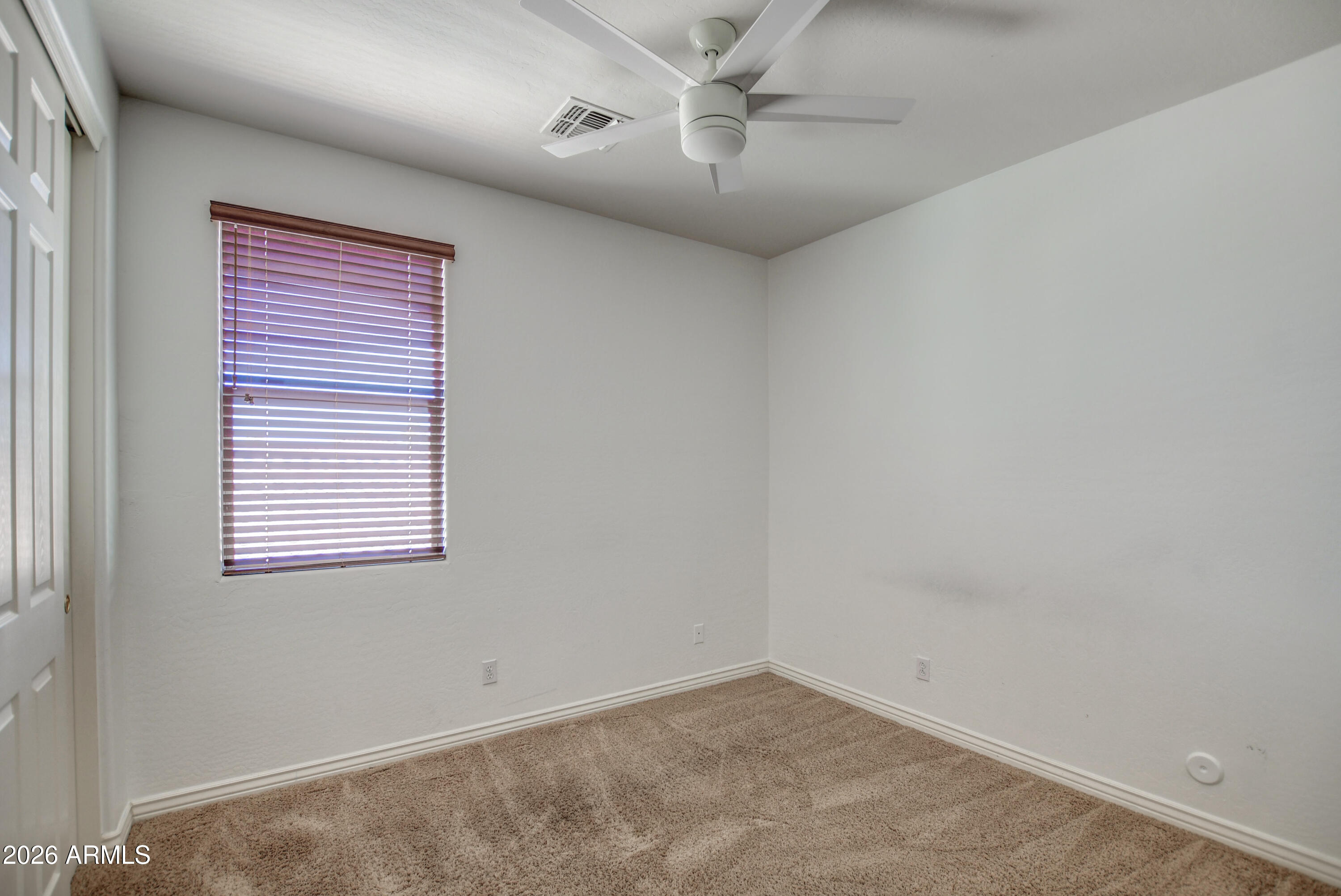 3078 East Muirfield Street Gilbert, AZ 85298 - Photo 71 of 92 an empty room with a window and a fan