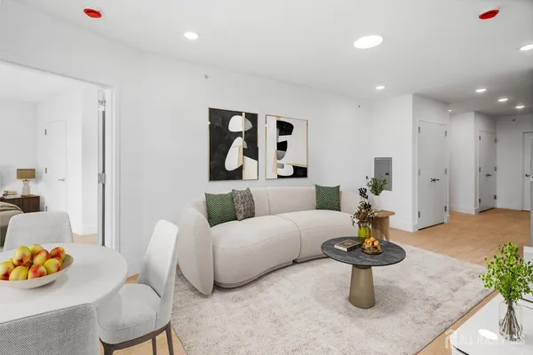 a living room with furniture and a potted plant